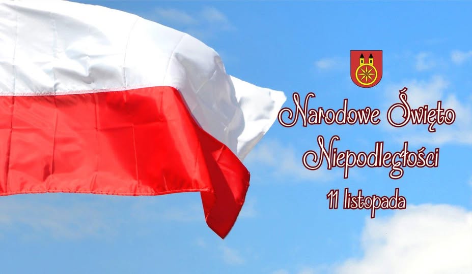 Zdjęcie przedstawia flagę biało-czerwoną po lewej stronie oraz napis Narodowe Święto Niepodległości 11 Listopada po prawej, umieszczone na tle błękitnego, pogodnego nieba. Całość utrzymana jest w patriotycznym i uroczystym tonie.