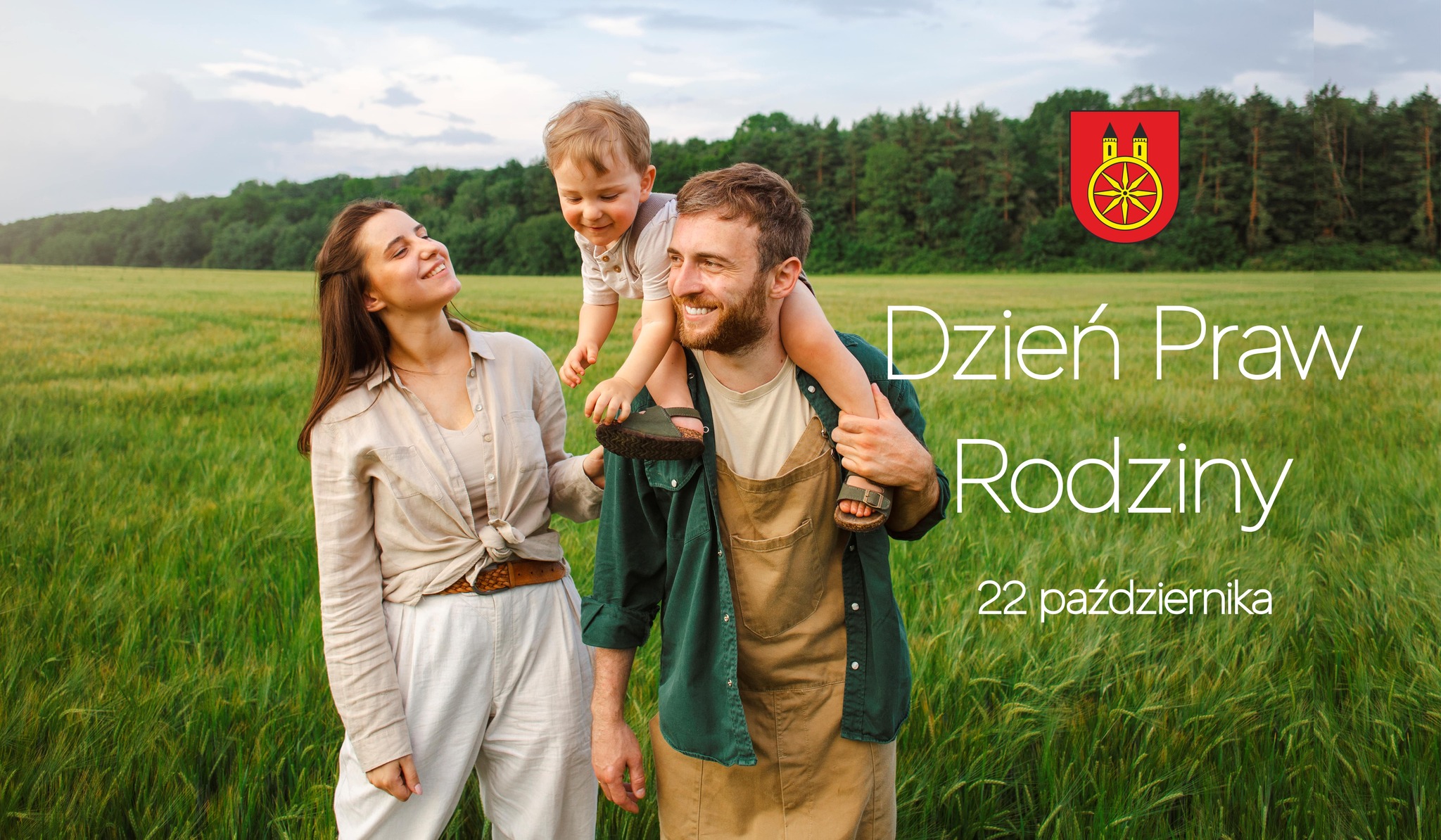 Plansza promująca Dzień Praw Rodziny, który przypada 22 października. W prawym górnym rogu znajduje się herb miasta Koła. W centrum planszy widzimy uśmiechnięta kobietę i mężczyznę, który trzyma na ramionach uśmiechniętego małego chłopca.